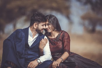 Selective Focus Photography of Man and Woman Sitting on Ground