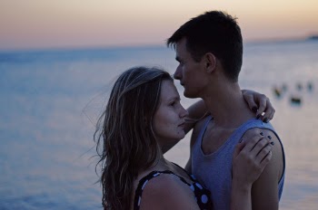 Selective Focus Photography of Man and Woman Standing Near Seashore