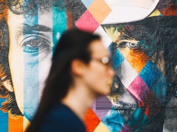 selective focus photography of man face wall art