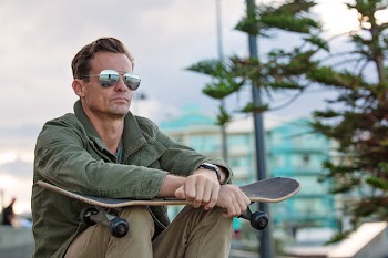 Selective Focus Photography of Man Holding Black and Brown Skateboard
