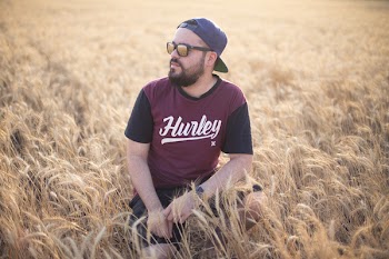 Selective Focus Photography of Man in Crouch Position on Wheat Field