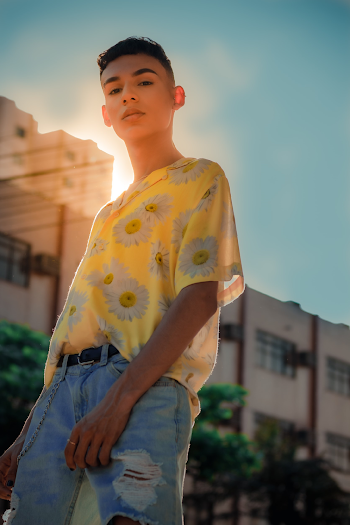 Selective Focus Photography of Man in Daisy-print Shirt and Distressed Jeans Outfit