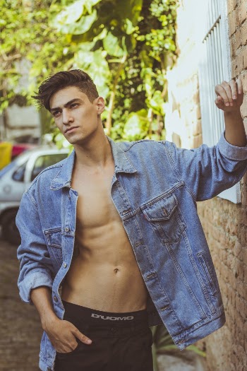 Selective Focus Photography of Man Leaning His Arm on Wall