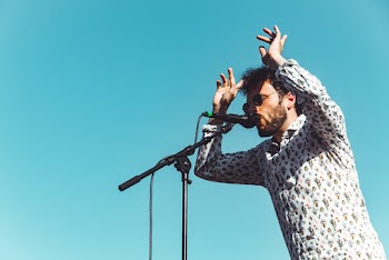 Selective Focus Photography of Man Singing on Stage