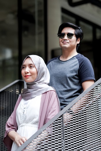 Selective Focus Photography of Man Standing Behind Standing Woman Wearing Gray Hijab