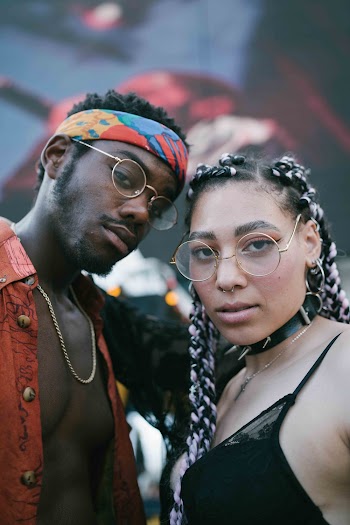 Selective Focus Photography of Man Standing Beside Woman Wearing Eyeglasses