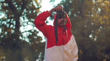 Selective Focus Photography of Man Standing Holding Dslr Camera