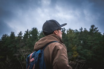 Selective Focus Photography of Man Standing Near Trees