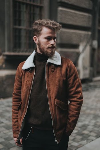 selective focus photography of man standing on sidewalk