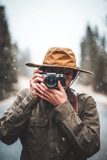 selective focus photography of man taking photo