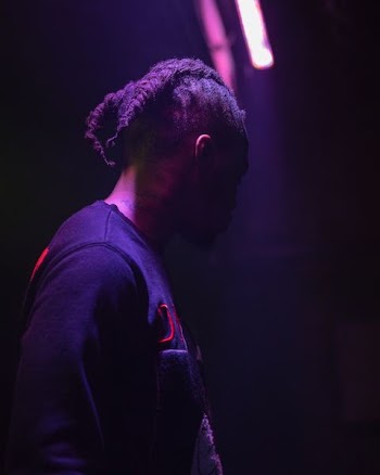 selective focus photography of man wearing black shirt looking down