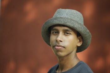 Selective Focus Photography of Man Wearing Gray Fedora Hat and Gray Crew-neck Shirt
