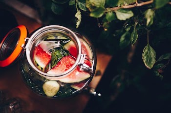 selective focus photography of mason jar filled with liquid