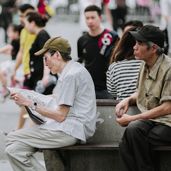 Selective Focus Photography of Men Sitting on Chair Outdoor