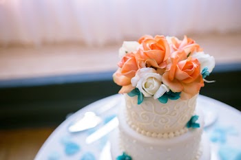 Selective Focus Photography Of Orange And White Rose Flowers On Round 2-layer Cake 