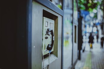 selective focus photography of payphone at daytime