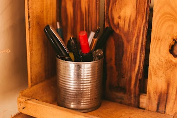 Selective Focus Photography of Pens in Silver Can