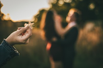 Selective Focus Photography of Person Holding Dandelion