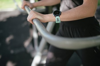 Selective Focus Photography of Person Holding on Rail