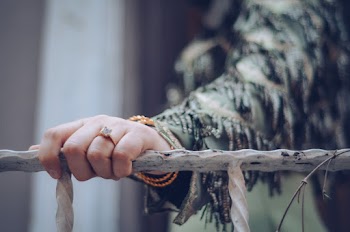 Selective Focus Photography Of Person Holding On Rail