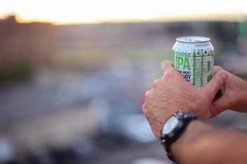 Selective Focus Photography of Person Holding Soda Can