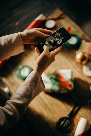 Selective Focus Photography of Person Taking Photo of Table