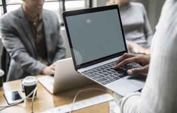 Selective Focus Photography of Person Using Laptop