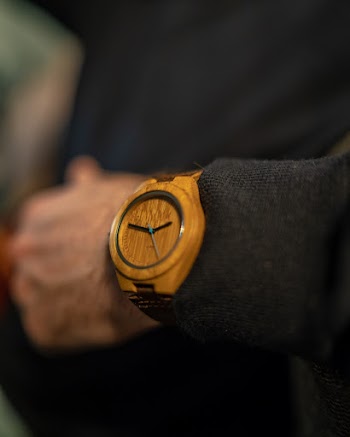 Selective Focus Photography of Person Wearing Round Brown Analog Watch