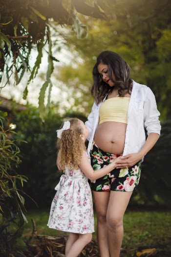 Selective Focus Photography of Pregnant Woman Standing Beside Girl