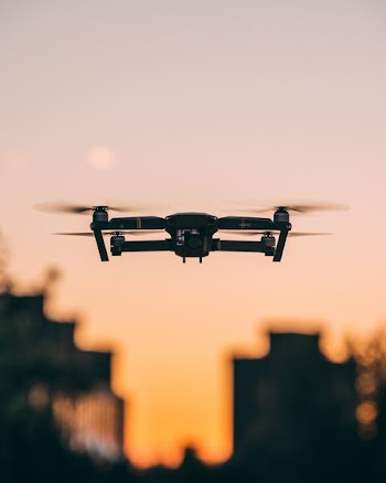 selective focus photography of quadcopter drone in mid-air