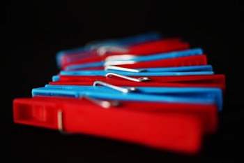 Selective Focus Photography of Red and Blue Clothes Pins