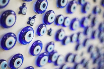 Selective Focus Photography of Round Blue Gemstone Lot on White Surface