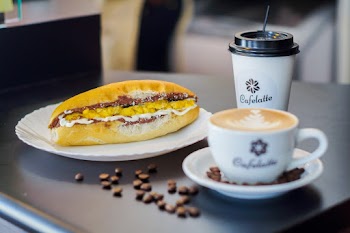 Selective Focus Photography of Sandwich Beside Cup
