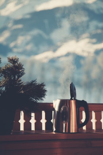 Selective Focus Photography of Silver Electric Kettle Beside Gray Balustrade