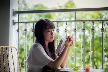Selective Focus Photography of Sitting Woman Reading Book