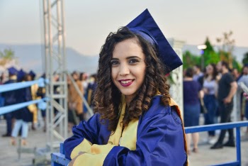 Selective Focus Photography  of Smiling Woman in Graduation Gown