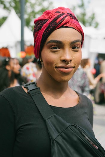 Selective Focus Photography of Smiling Woman Wearing Red and Black Headdress