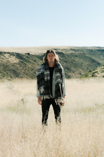 Selective Focus Photography of Standing Man Wearing Scarf