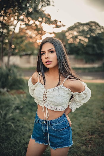 Selective Focus Photography of Standing Woman Wearing White Crop Top