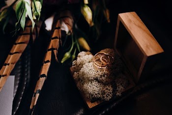 selective focus photography of three gold-colored rings with box