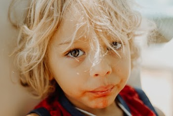 Selective Focus Photography of Toddler With Food Scattered On His Mouth