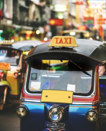 Selective Focus Photography of Two Blue and Yellow Auto Rickshaws on Road
