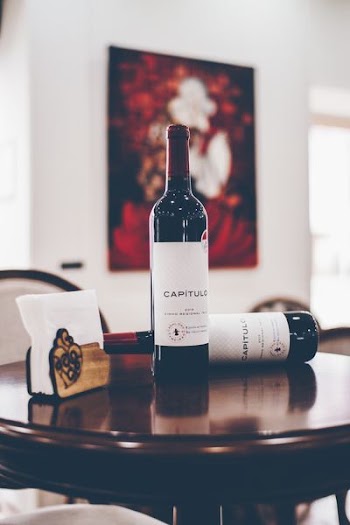 selective focus photography of two Capitulo bottles on table