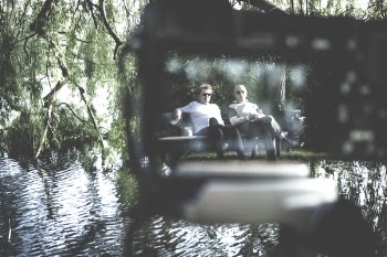 Selective Focus Photography of Two Men Sitting on Bench