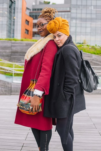 Selective Focus Photography of Two Women Standing Near Buildings 