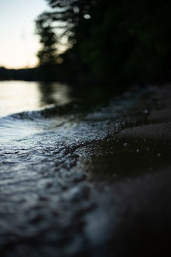 selective focus photography of water crashing on land at daytime