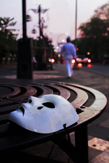 Selective Focus Photography of White Mask on Brown Table
