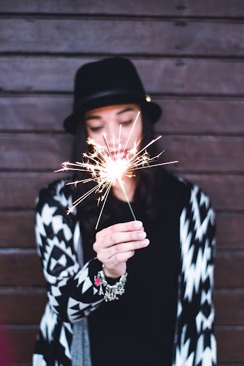 Selective Focus Photography of Woman's Hand Holding Sparkle