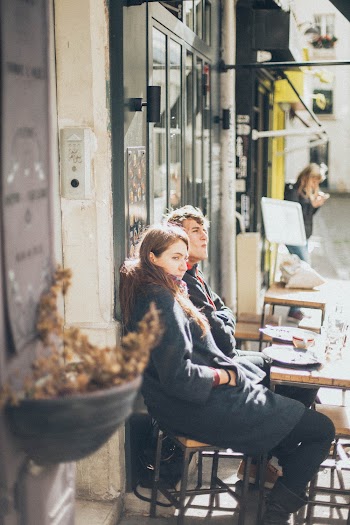 Selective Focus Photography of Woman and Man Sitting on Dining Set
