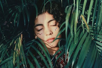 Selective Focus Photography of Woman Behind Plants